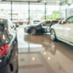 new cars in showroom interior blurred abstract background