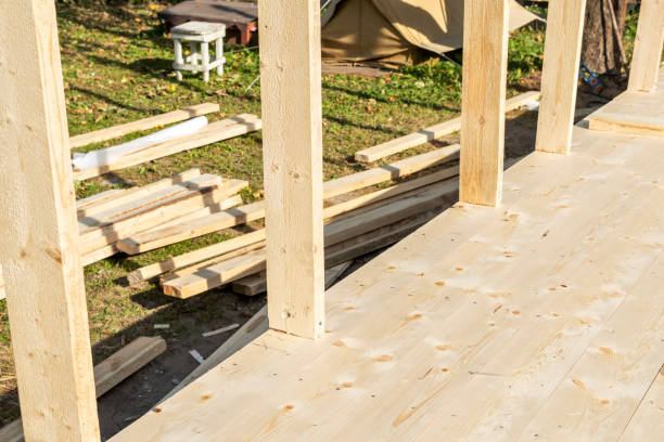 Outdoor construction site with vertical wooden beams for a frame house