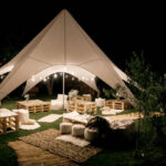 Spacious tent in the garden for a wedding party.
