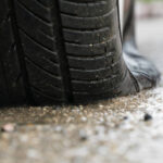 flat tire car in rainy day on stret.