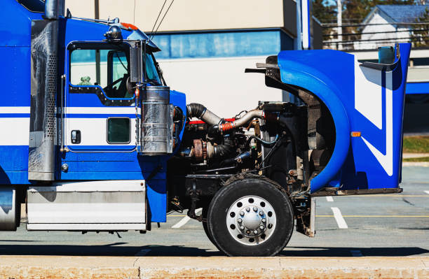 Broken down semi truck in a parking lot.