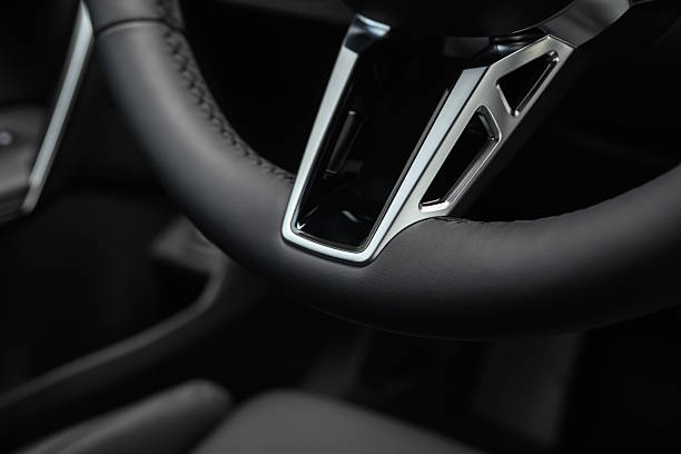 Detailed view of a premium leather steering wheel with silver trim.