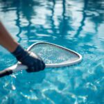 lucid-origin_Close-up_shot_of_gloved_hands_skimming_a_sparkling_blue_pool_surface_with_a_net_-0