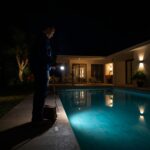 lucid-origin_Technician_arriving_at_night_with_a_flashlight_and_toolkit_beside_a_villa_pool_u-0