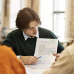 man-studying-grammar-with-his-colleagues
